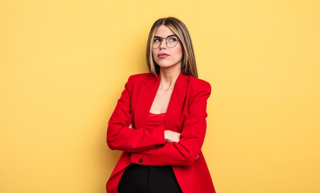 Businesswoman shrugging, feeling confused and uncertain