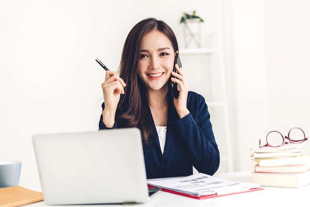 Businesswoman sitting and working with laptop