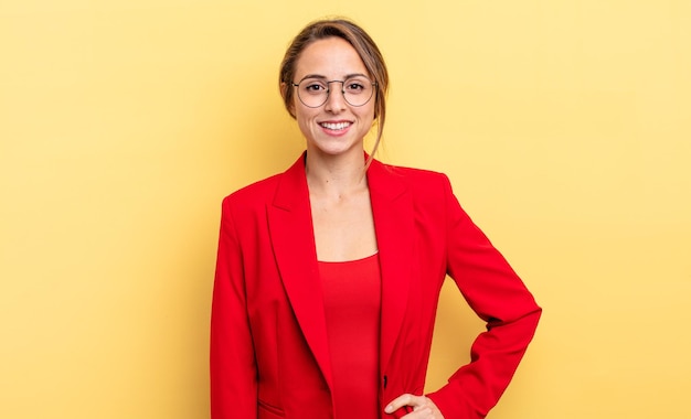 Businesswoman smiling happily with a hand on hip and confident