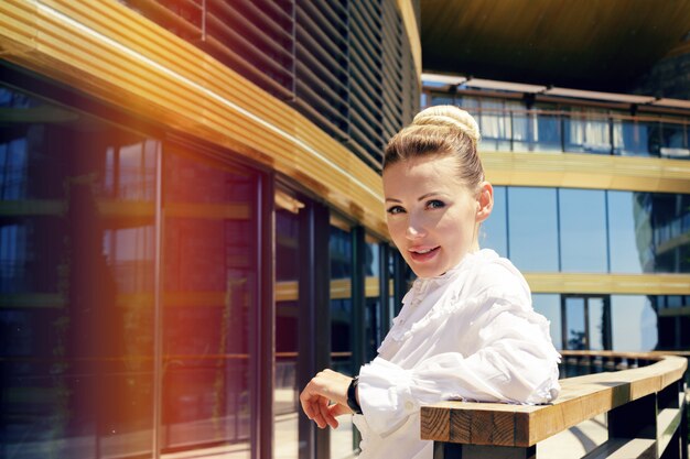 Businesswoman standing next to her office in the morning