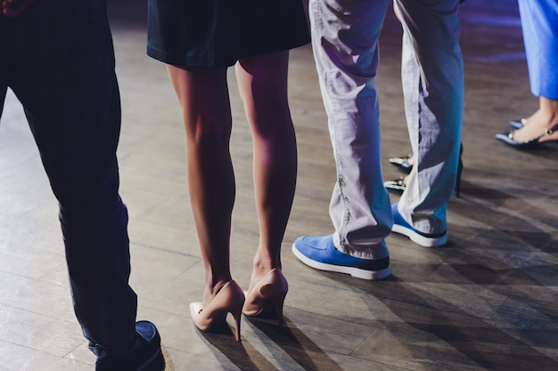 Businesswoman standing out of the crowd female feet close-up.