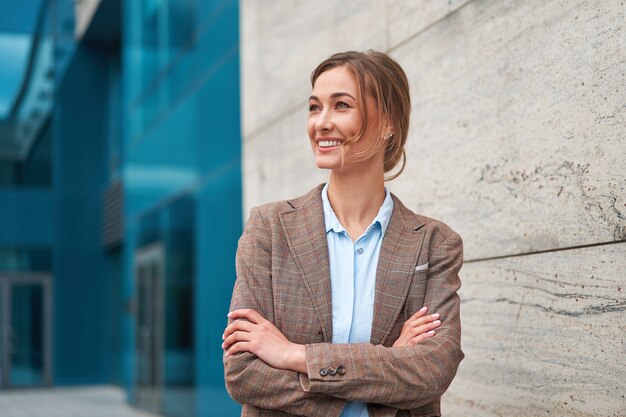 Businesswoman standing outdoor corporate building