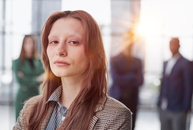 businesswoman standing with her arms crossed in an office