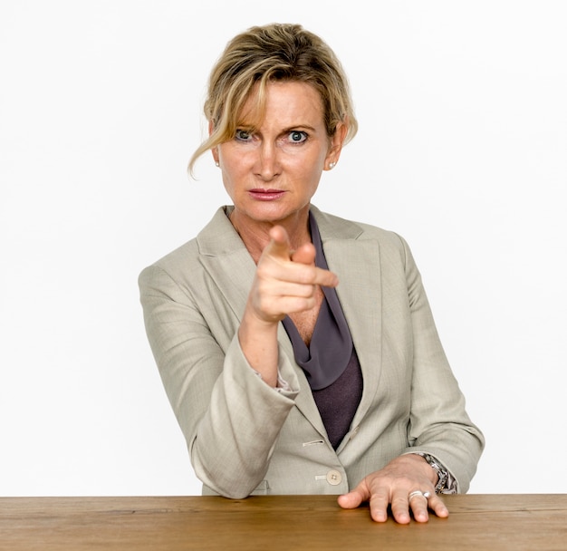 Businesswoman in a studio with wooden table