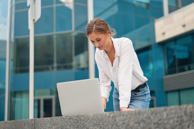 Businesswoman successful woman business person outdoor corporate building exterior Pensive caucasian confidence professional business woman middle age