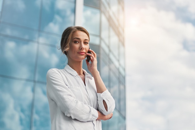 Businesswoman successful woman business person standing outdoor corporate building exterior Pensive caucasian confidence professional business woman middle age