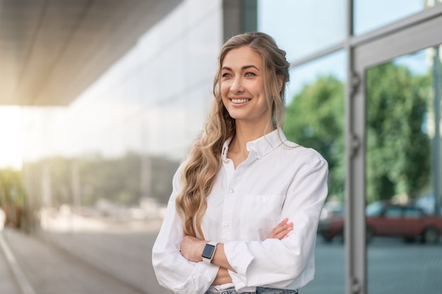 Businesswoman Successful Woman Smiling Business Person Standing Outdoor Corporate Building Exterior. Happy Caucasian Confidence Professional Business Woman Middle Age Female White Shirt Big Window