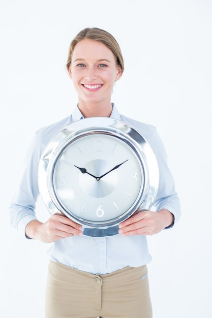 Businesswoman in suit holding a clock