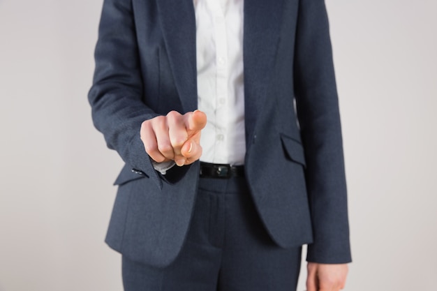 Businesswoman in suit pointing finger