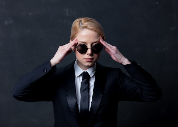 Businesswoman in sunglasses with headache