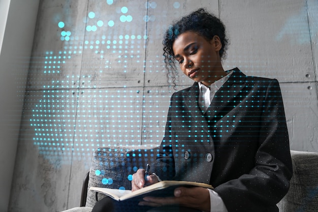 Businesswoman taking notes and world map hologram Double exposure Technology security network solution planet earth international business concept