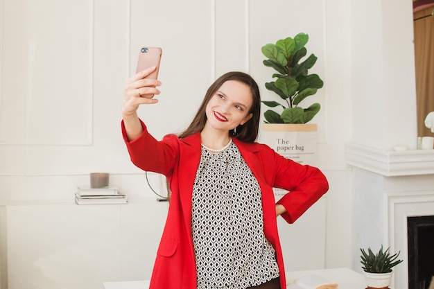 Businesswoman taking a selfie in the office