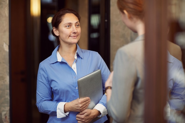 Businesswoman talking to employee