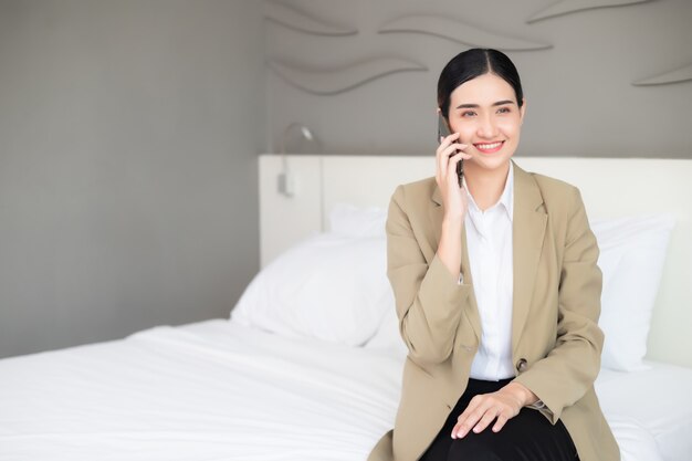 businesswoman talking on the phone in bedroom