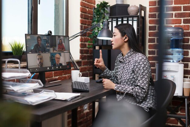 Businesswoman talking on video conference at office