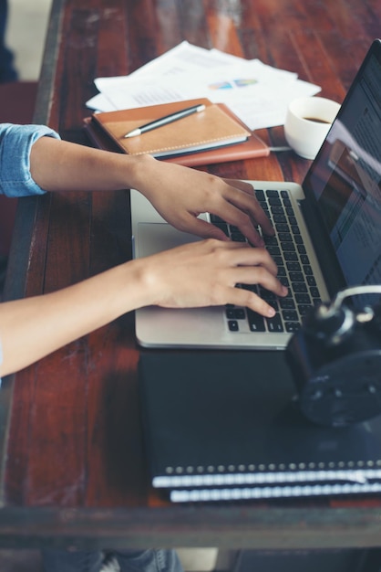 Businesswoman typing on laptop at office