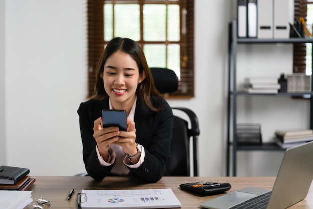 Businesswoman typing message to chatting on smartphone and working with planning for marketing plan