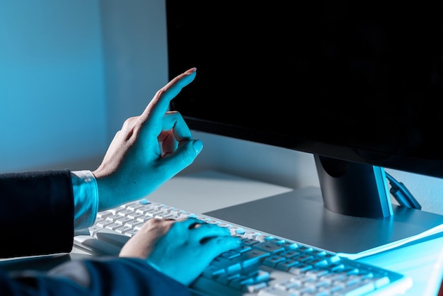 Businesswoman typing recent updates on lap top keyboard on desk and pointing important ideas with