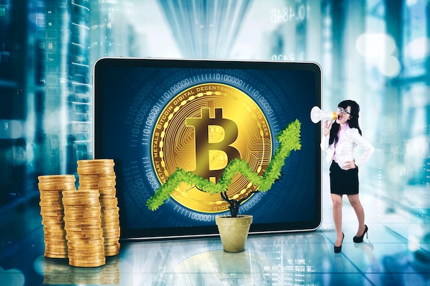 Businesswoman use a megaphone near bitcoin symbol