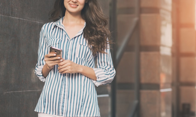 Businesswoman uses a mobile phone.