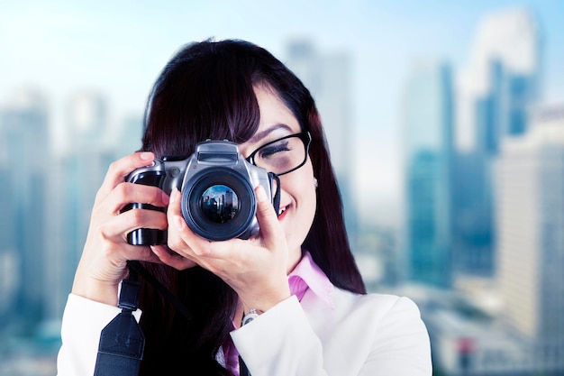 Businesswoman using camera to taking city picture