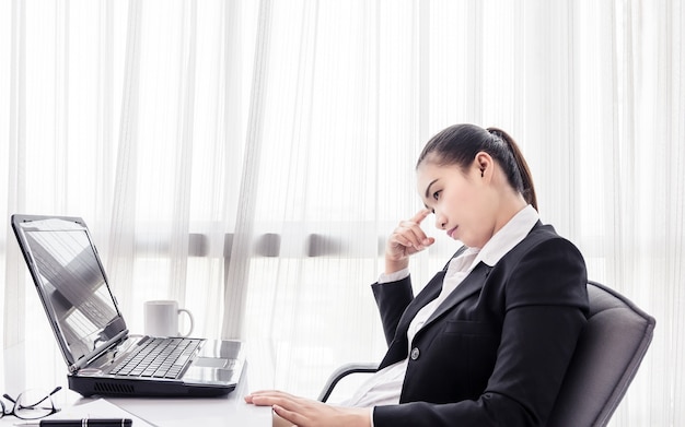 Businesswoman using computer in the office. Stress in the office