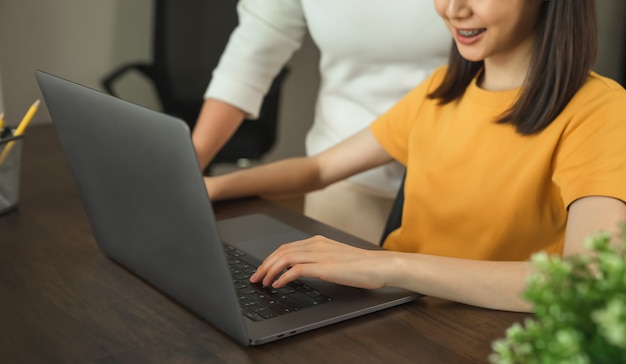 Businesswoman using digital laptop and working on the table in the office.