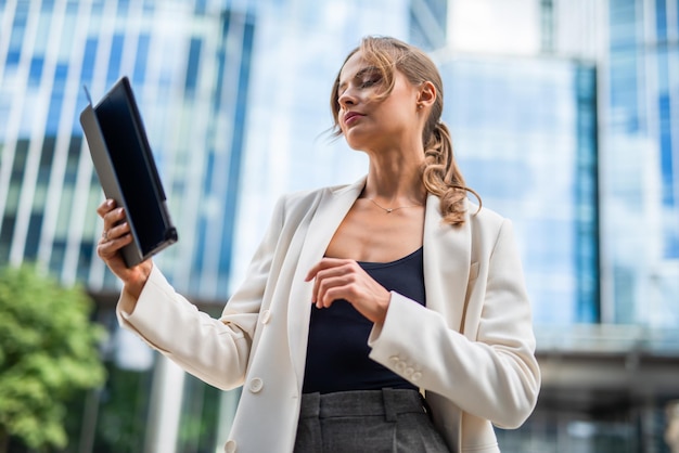 Businesswoman using a digital tablet outdoor