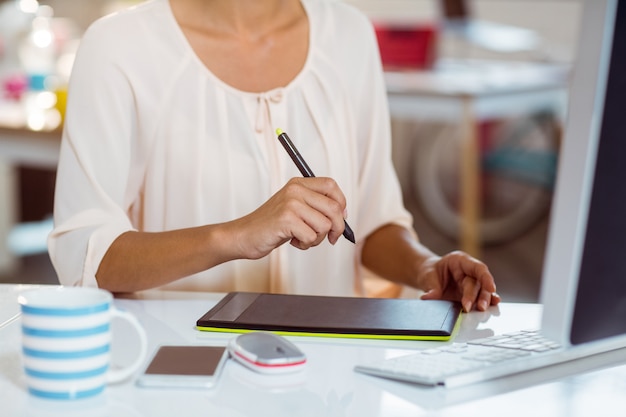 Businesswoman using graphic tablet