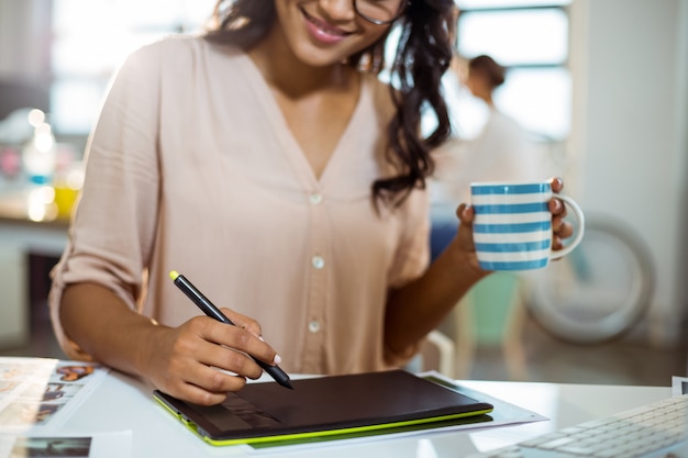 Businesswoman using graphic tablet