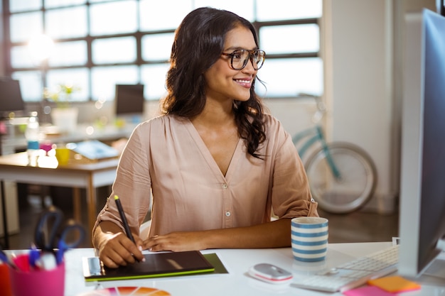 Businesswoman using graphic tablet