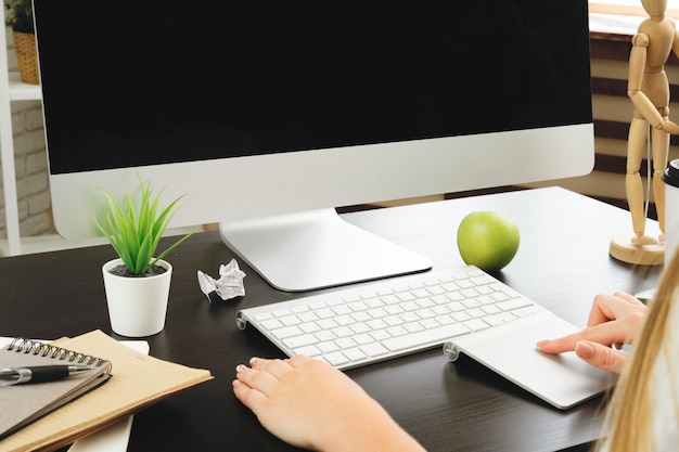 Businesswoman using her computer at an office or at home