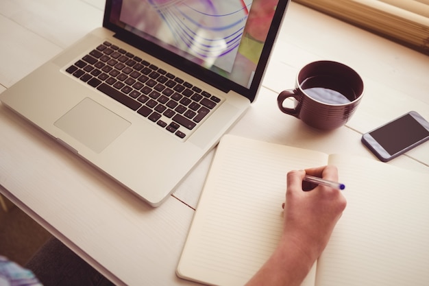 Businesswoman using her laptop at desk