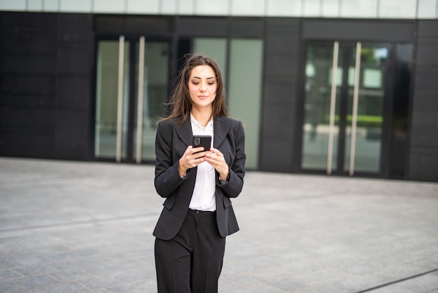 Businesswoman using her mobile cell phone