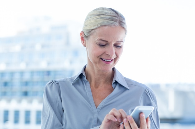 Businesswoman using her smartphone