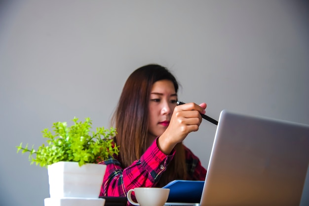 Businesswoman using laptop computer. Male hand typing on laptop keyboard