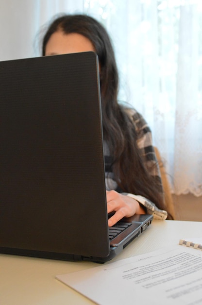 Businesswoman using laptop on desk in office