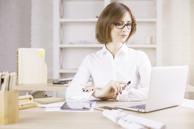 Businesswoman using laptop at desk