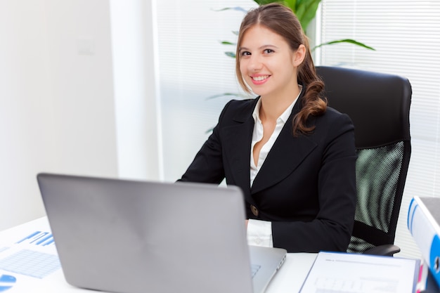 Businesswoman using a laptop in her office