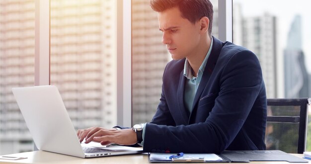 Businesswoman using laptop at office