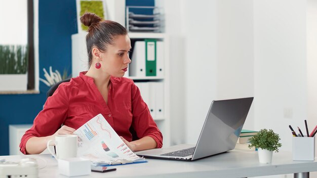 Businesswoman using laptop at office