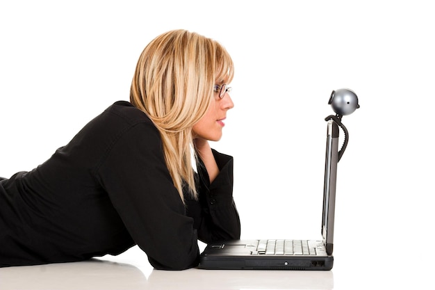 Businesswoman using laptop and webcam