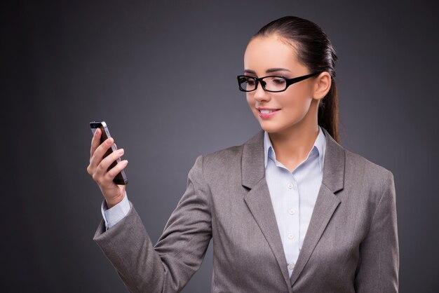 Businesswoman using mobile phone in business concept