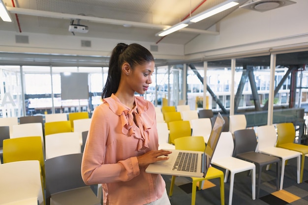 Businesswoman using mobile phone in the conference room at office