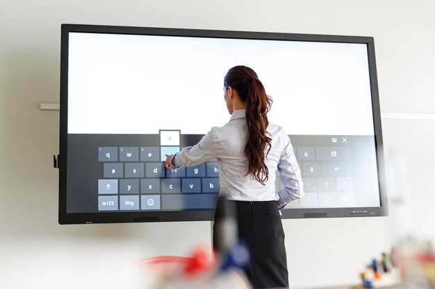 Businesswoman using projection of a keyboard in conferene room