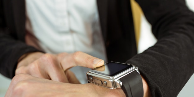 Businesswoman using a smart watch