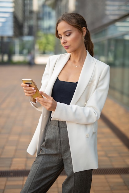 Businesswoman using a smartphone outdoor