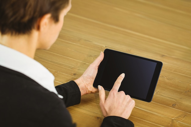 Businesswoman using tablet at desk