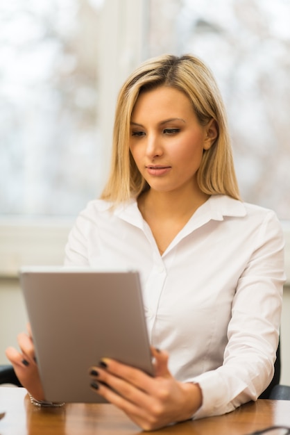 Businesswoman using a tablet in her office