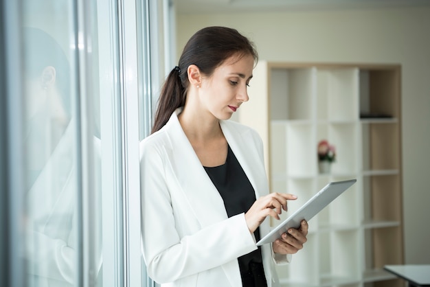 businesswoman using a tablet social media technology.